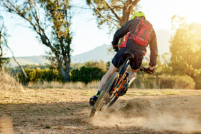 Buy stock photo Mountain bike, fitness and back of athlete with sports race, workout or cardio exercise on dirt road. Cycling, triathlon and cyclist riding on dust trail for competition training with adventure.