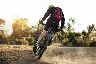 Buy stock photo Bike, dust and sports with man in mountains for outdoor adrenaline, adventure or training. Exercise, fitness and hobby with back of person cycling in nature for challenge, competition or performance
