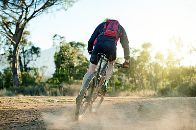 Buy stock photo Bike, dirt road and sports with man in mountains for outdoor adrenaline, adventure or training. Exercise, fitness and dust with person cycling in nature for challenge, competition or performance