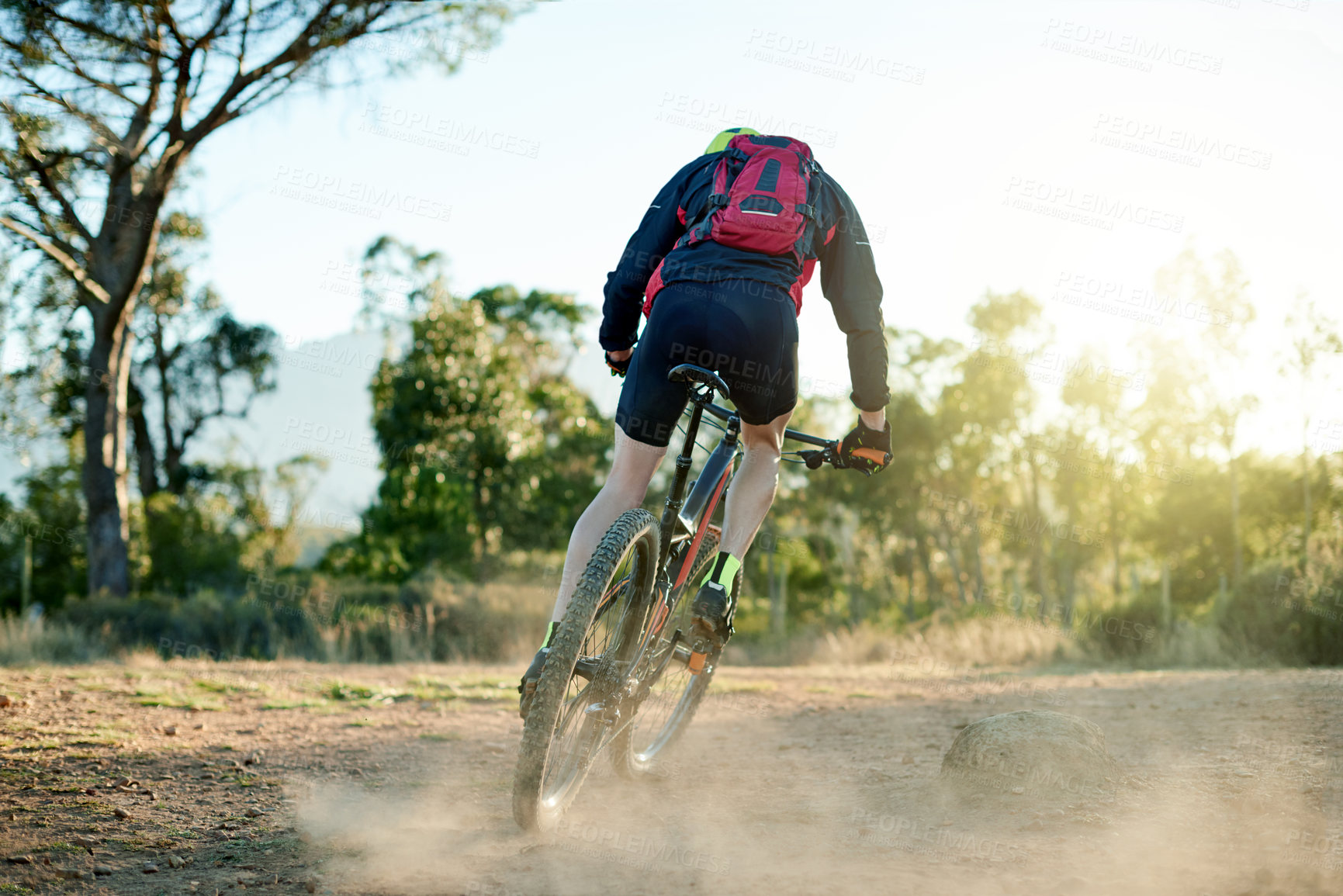 Buy stock photo Bike, dirt road and sports with man in mountains for outdoor adrenaline, adventure or training. Exercise, fitness and dust with person cycling in nature for challenge, competition or performance