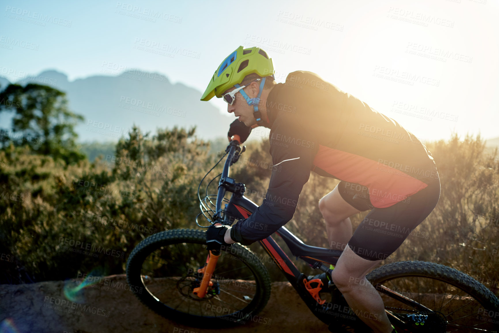 Buy stock photo Man, mountain bike and cycling with bicycle in nature for adrenaline rush, fitness or extreme sport on dirt road. Male person, cyclist or riding helmet for cardio workout on path or natural trail