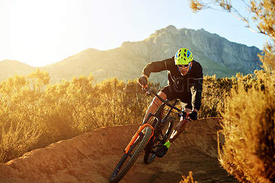 Buy stock photo Man, cyclist and mountain with sunset or bicycle on dirt track for adrenaline rush, fitness or extreme sport in nature. Male person, cycling or riding with bike for cardio on path, road or trail