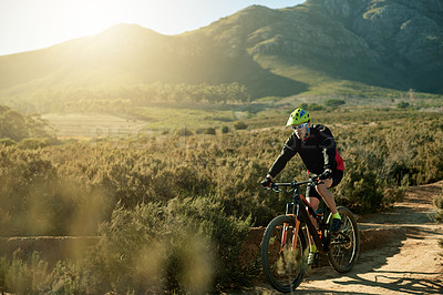 Buy stock photo Man, cyclist and mountain bike with dirt road for cardio workout, outdoor adventure or extreme sport in nature. Male person, bicycle and cycling with helmet for adrenaline on path or natural trail