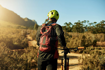 Buy stock photo Man, walking and bike on mountain for fitness, journey and travel break on trail. Back, athlete and bicycle on nature path for landmark search, explore track and enjoy view at sky space in Australia