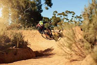 Buy stock photo Bike, extreme sports and speed with man in mountains for outdoor adrenaline, adventure or training. Exercise, fast and fitness with person cycling in nature for challenge, competition or performance