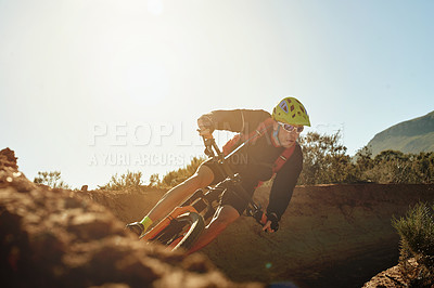 Buy stock photo Bike, helmet and trail with man in mountains for outdoor adrenaline, adventure or training. Balance, exercise or fitness and person cycling off road for challenge, competition or performance hobby