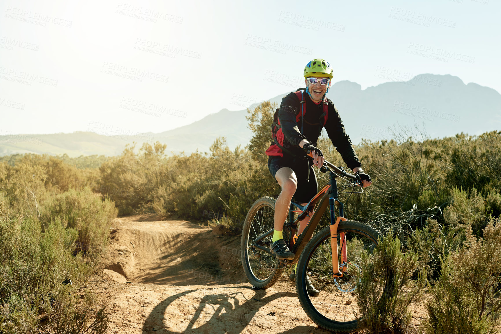 Buy stock photo Bike, smile and sports with man on mountain trail for adrenaline, adventure or training. Exercise, excitement and fitness with happy person cycling in nature for challenge, competition or performance