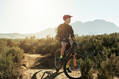 Buy stock photo Bike, sports and thinking with man in mountains for adrenaline, adventure or training. Exercise, fitness and view with person cycling off road in nature for challenge, competition or performance