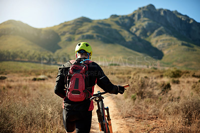 Buy stock photo Man, tired and walking on mountain with bike, journey and travel with flat tire on trail. Back, athlete and bicycle on nature path for explore track, backpacking adventure and exercise in Australia