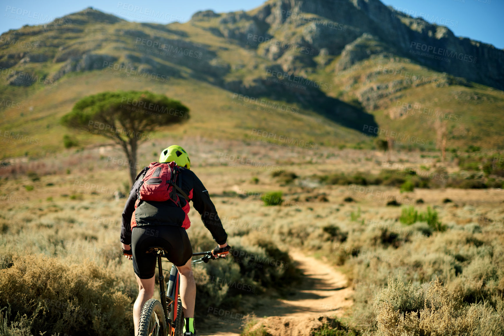 Buy stock photo Back, bike and off road with man in mountains for outdoor exercise, fitness or hobby. Journey, space and trail with person cycling in scenic nature for challenge, performance or sports training