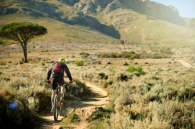 Buy stock photo Back, cycling and dirt road with man in mountains for outdoor exercise, fitness or hobby. Scenic, trail riding and view with cyclist on space in nature for challenge, performance or sports training