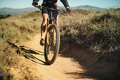 Buy stock photo Bike, dirt road and wheel with person in mountains for outdoor exercise, fitness or hobby. Balance, trail riding and tyre with cyclist in nature for challenge, performance or sports training