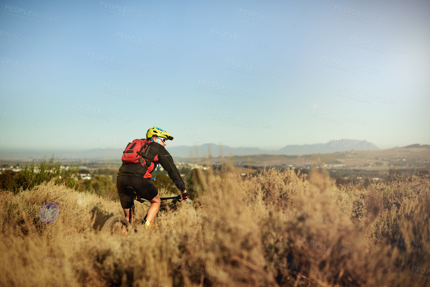 Buy stock photo Backpack, cycling and off road with man in mountains for outdoor exercise, fitness or hobby. Bike, helmet and trail riding with cyclist person in nature for adventure, performance or sports training