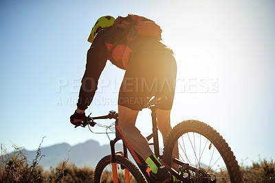 Buy stock photo Adventure, bike and sports with man in nature from back for action, challenge or health in mountains. Exercise, fitness and training with cyclist person outdoor for hobby, journey or recreation