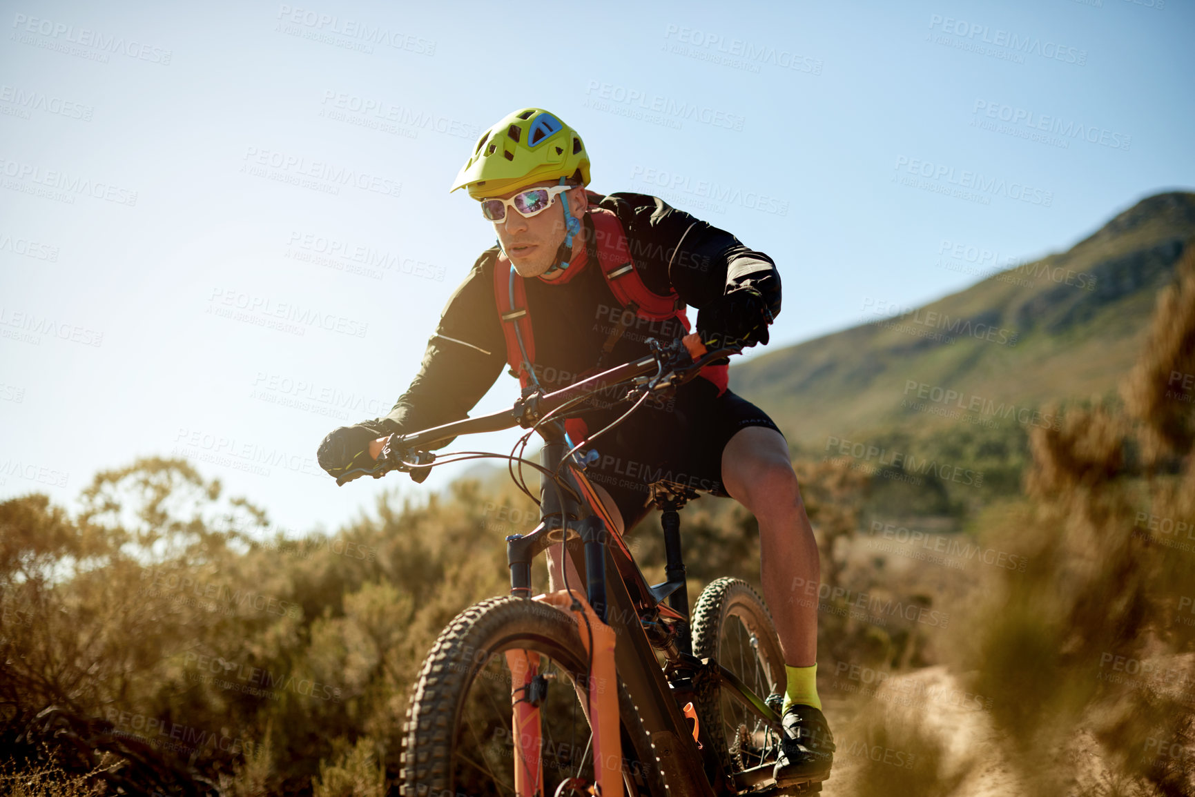 Buy stock photo Bike, off road and sports with man in mountains for outdoor adrenaline, adventure or training. Exercise, fitness and hobby with person cycling in nature for challenge, competition or performance