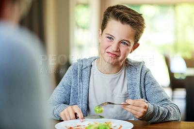 Buy stock photo Upset, child and reject food at dinner table for eating vegetables and no to nutrition at home. Healthy, brussel sprout and face with disgust, refuse and fussy eater with balanced diet and salad