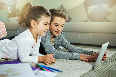 Buy stock photo Education, tablet and video with children on floor of living room in home together for distance learning. Movie, school or web with brother and sister sibling students in apartment for development