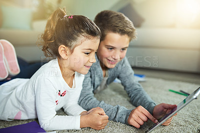 Buy stock photo Children, smile and relax in home with tablet, online game and streaming media on homework break. Kids, siblings and technology in living room for cartoon video, app subscription and weekend bonding