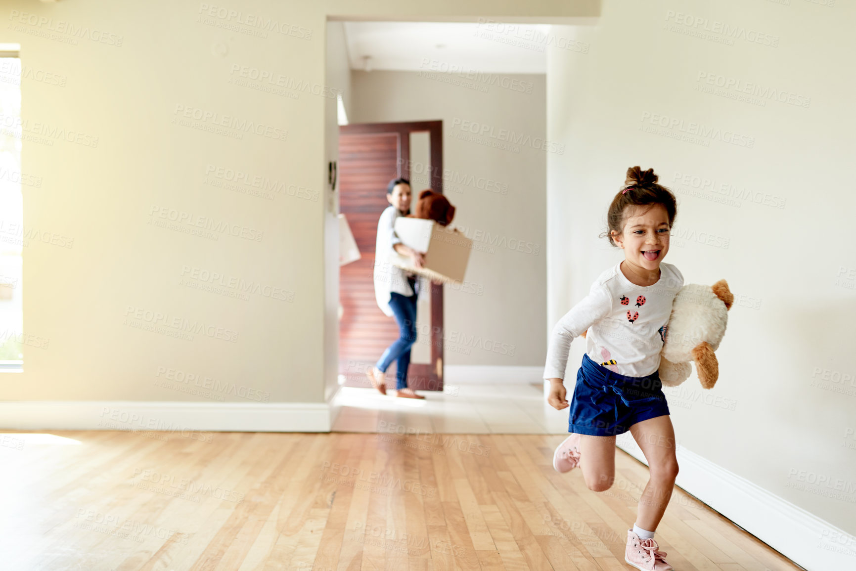 Buy stock photo Excited, child and running for moving to new home with playful energy, joyful movement and explore property. Happy, girl and parents with boxes for relocation, discovery game and apartment investment