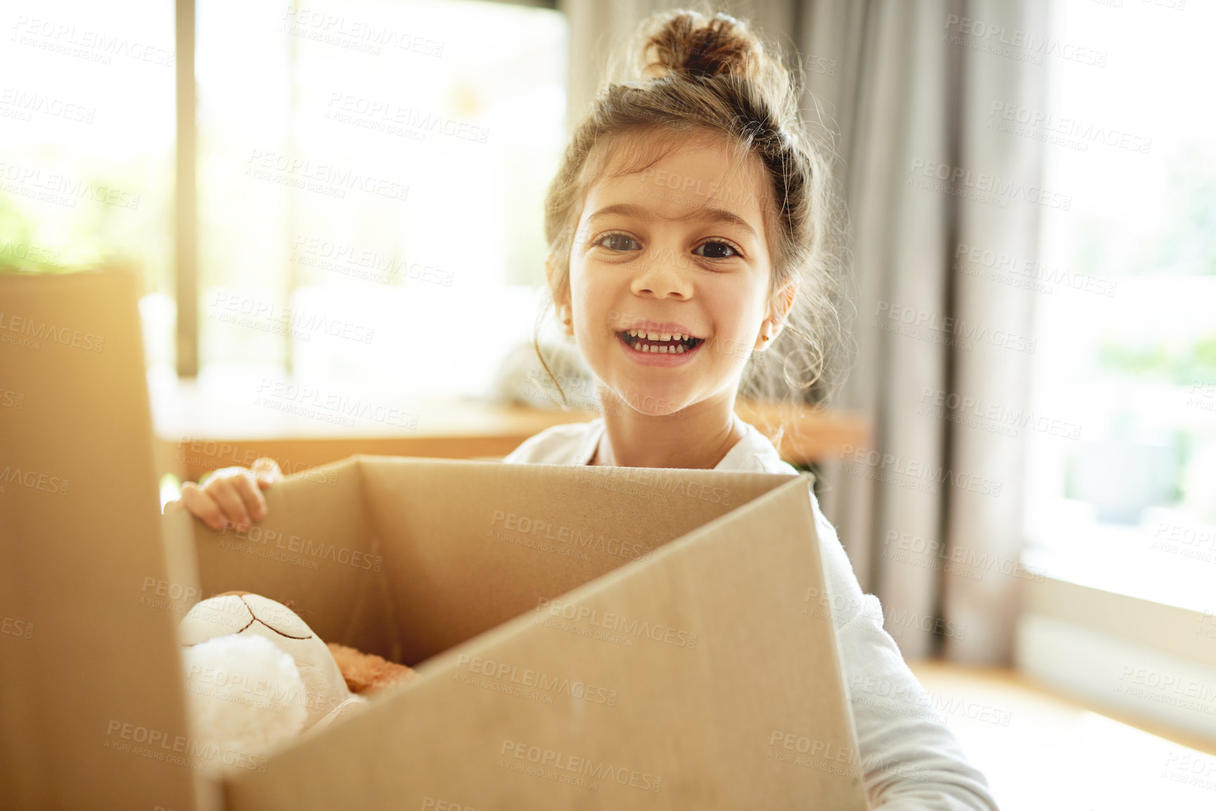 Buy stock photo Portrait, box and happy kid moving to new house, unboxing or pack for property relocation in dream home. Face, real estate or girl child with cardboard for donation, storage or carry toys for charity