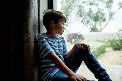 Buy stock photo Sad, boy kid and thinking by window with depression, abandoned or unhappy for loneliness. Person, orphan or mental health in home with gloomy weather, vulnerable or waiting on adoption at foster care