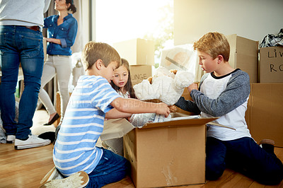 Buy stock photo Moving, boxes and children packing in new home with sorting items for donation, charity or community. Cardboard, fun and kids helping to sort household supplies for relocation in family house.