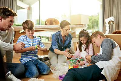 Buy stock photo Unpacking, family and boxes for moving, new home and parents with children in property and real estate. Living room, woman and man with kids in house, mortgage or milestone with investment for people