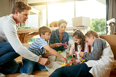 Buy stock photo Real estate, family and boxes for moving, new home and parents with children in property and unpacking. Living room, woman and man with kids in house, mortgage or milestone with investment for people