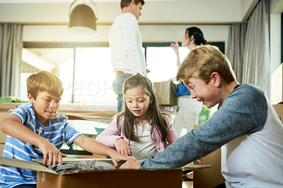 Buy stock photo Real estate, unpacking and children with toys, home and siblings with boxes for move or excited. Living room, family and parents with investment of property, happy or kids with cardboard in new house