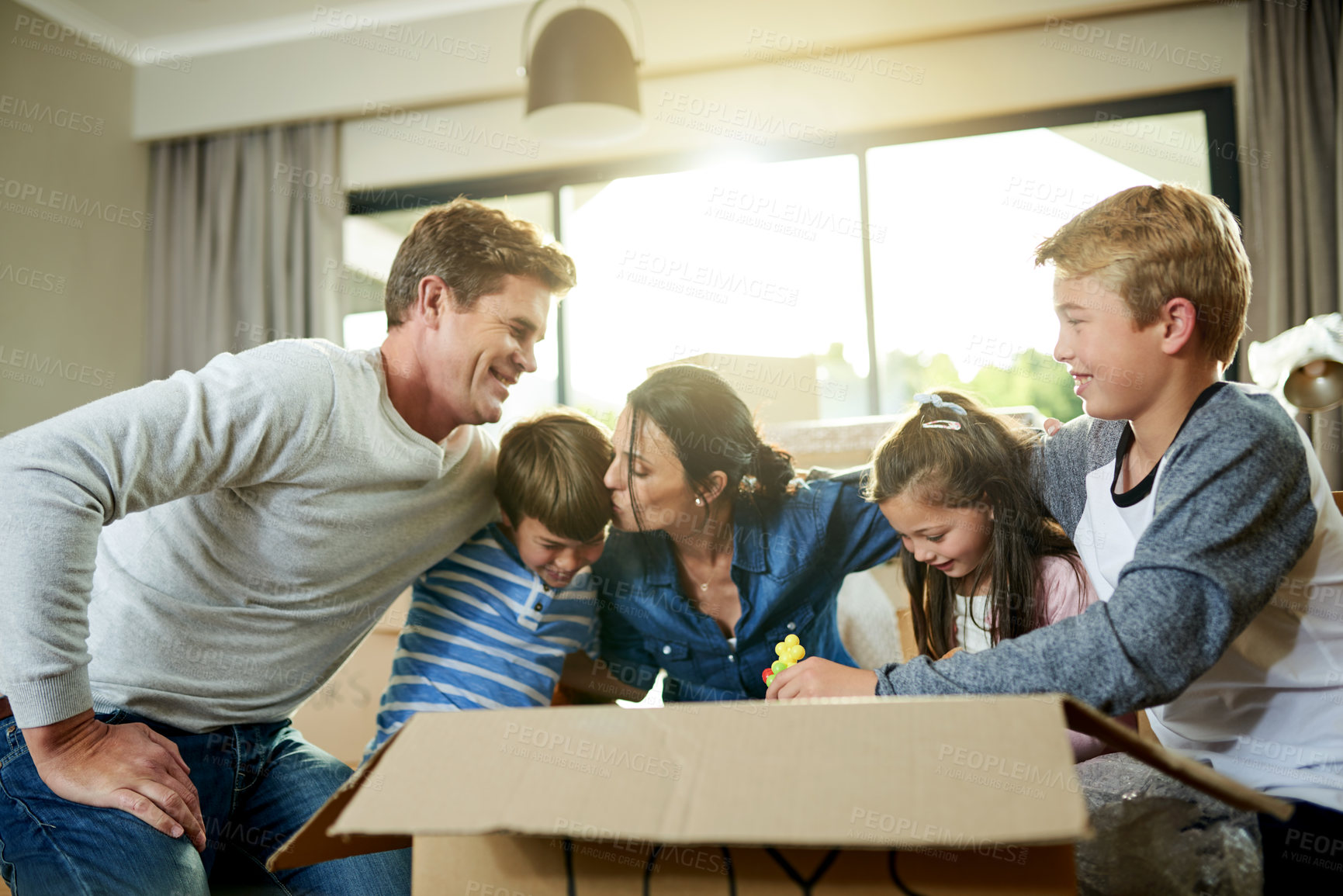 Buy stock photo Bonding, boxes and family packing in new home with sorting items for donation, charity or community. Cardboard, love and parents helping children sort household supplies for moving in house.