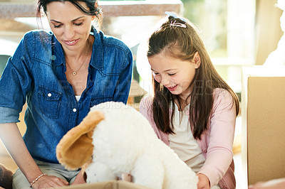 Buy stock photo Moving, family and mom with child, boxes and smile for new home, unpacking and real estate for woman. Investment, ownership and person with daughter in living room, love and mortgage for house