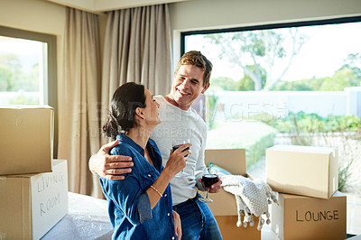 Buy stock photo Happy couple, wine and boxes in home for move, milestone celebration and bonding on break. Property investors, people or relax in living room for mortgage success, new house or excited for investment