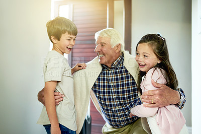 Buy stock photo Hug, love or visit with grandpa and children in home together for bonding, relationship or retirement. Family, smile or welcome with senior man embracing excited boy and girl kids in apartment