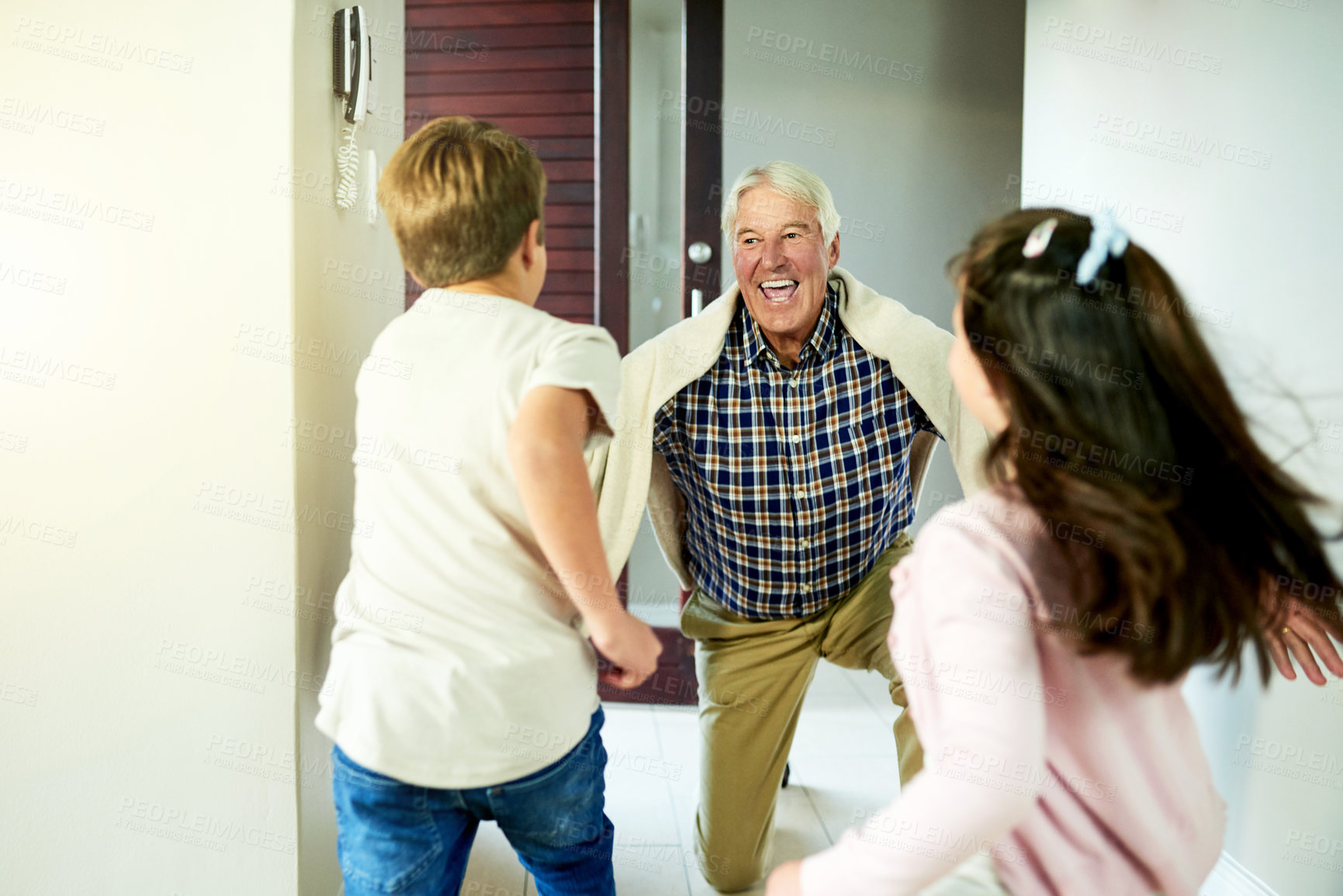 Buy stock photo Children, running and happy for grandfather visit in home with arrival greeting, hello and reunion welcome. People, family connection and support by front door with bonding together and relationship