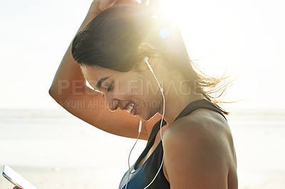 Buy stock photo Exercise, beach and podcast with woman prepare for running, workout and happy with audio. Athlete, warm up or ready to start jog for fitness with music or health for wellness sports training