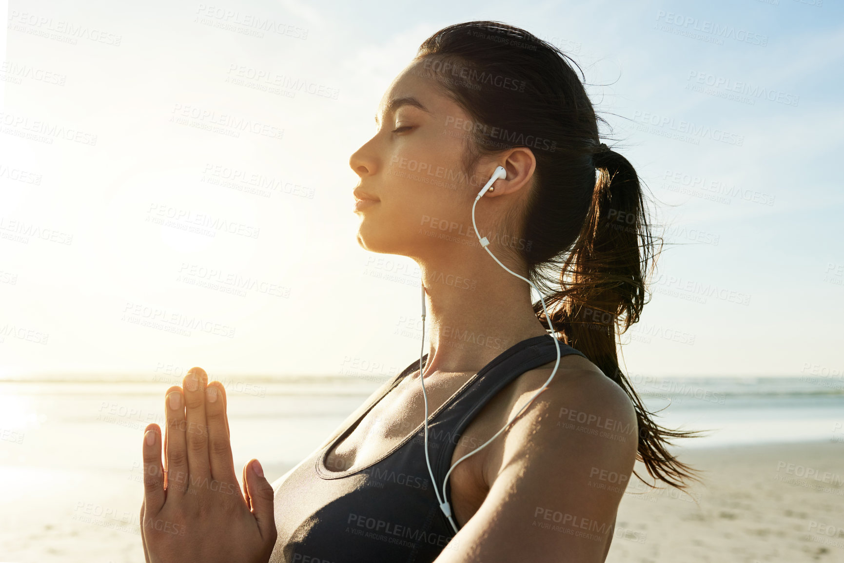 Buy stock photo Girl, earphones or beach meditation for sunset zen, manifestation or mindfulness gratitude. Mudra, namaste or binaural frequency music for mental health, wellness or anxiety relief in nature space