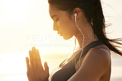 Buy stock photo Beach, meditation and woman with earphones, listening and mindfulness with chanting for peace, music or outdoor. Namaste, nature and streaming mantras on radio, calm and self awareness for person