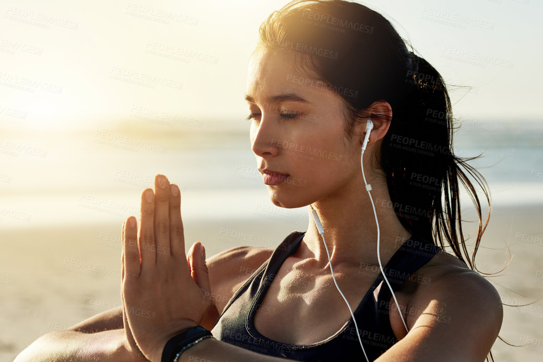 Buy stock photo Beach, meditation and woman with earphones, hands and listening to chanting for peace, zen or outdoor. Namaste, mindfulness and streaming mantras on radio, calm or self awareness for music in nature