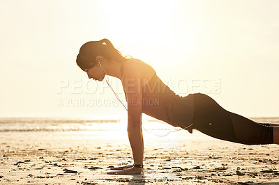 Buy stock photo Fitness, balance and woman at beach for push up, workout and exercise for active health or strong core. Sunset, music earphones and athlete at sea for outdoor training, wellness and muscle growth