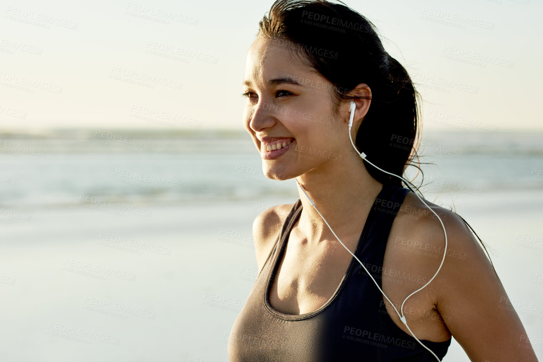 Buy stock photo Fitness, beach and mockup with woman smile for running, workout and summer goal with music. Athlete, earphones and ready to start jog for exercise, endurance or health for wellness sport training