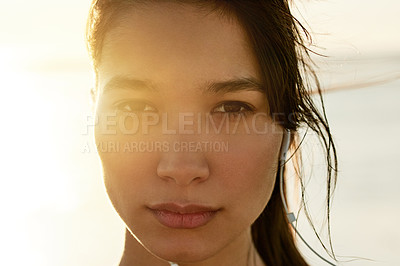 Buy stock photo Portrait, music and woman at beach on holiday, travel and listening to rock album at sunset. Face, outdoor and serious girl with earphones for audio, sound and streaming radio by ocean in Mexico