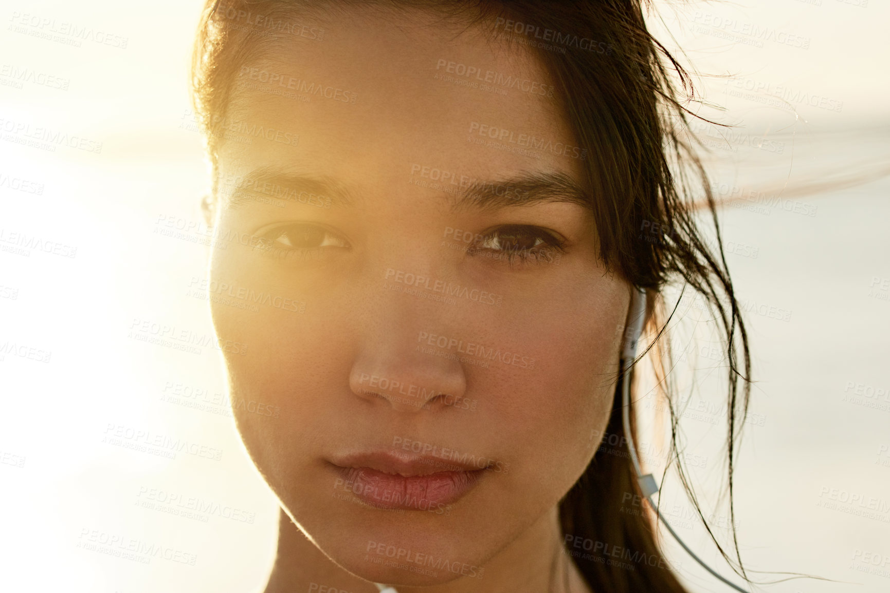 Buy stock photo Portrait, music and woman at beach on holiday, travel and listening to rock album at sunset. Face, outdoor and serious girl with earphones for audio, sound and streaming radio by ocean in Mexico