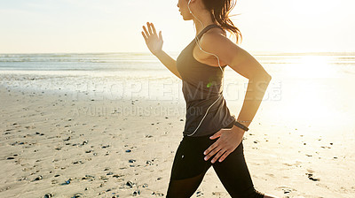 Buy stock photo Arms, running and woman on beach with music, sunrise and commitment to healthy outdoor workout. Earphones, training and girl runner at ocean for morning exercise, body wellness and jogging in nature.