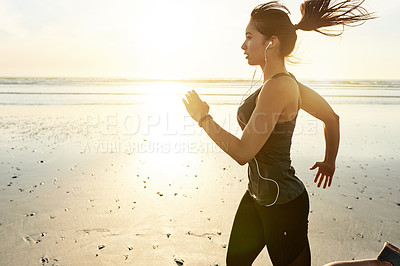 Buy stock photo Woman, beach and running at sunrise with earphones, training and listening to music with fitness in morning. Girl, person and sound with streaming, subscription and exercise with speed in Spain