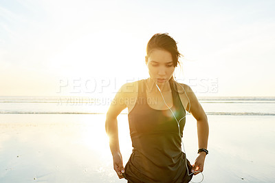 Buy stock photo Woman, relax and earphones of fitness at ocean from exercise, listening to music and training recovery. Female athlete, tired and resting for streaming audio, marathon practice and workout of burnout