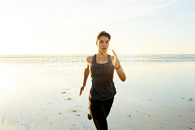 Buy stock photo Runner, music and woman running by beach for resistance training, cardiovascular health and endurance. Space, athlete and sprinting with earphones for marathon performance, workout and cardio fitness