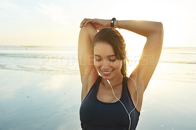 Buy stock photo Beach, earphones and happy woman stretching for fitness, healthy body and wellness at sunset. Warm up arms, music and athlete outdoor to prepare for exercise, training and ready for sports workout