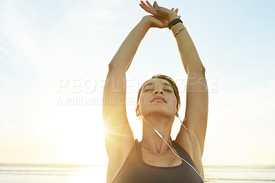 Buy stock photo Girl, stretching and earphones at beach, sunrise and ready for training in summer with streaming. Woman, person and workout with warmup, subscription and listen to music for fitness by ocean in Spain
