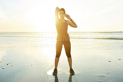 Buy stock photo Girl, stretching and earphones by ocean, sunrise and ready for training in summer with streaming. Person, woman and workout with warmup, subscription and listen to music for fitness at beach in Spain