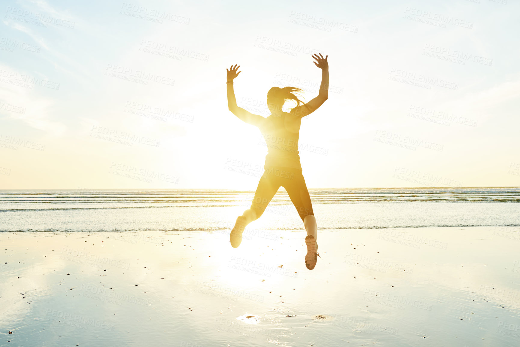 Buy stock photo Back, woman and jumping for fitness at beach with energy, freedom and celebration of exercise goals. Blue sky, female athlete and marathon winner with sports success, training achievement and beach